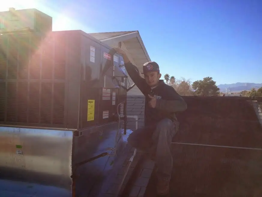 HVAC technician performing Air Duct Cleaning on a rooftop unit in Dyersburg